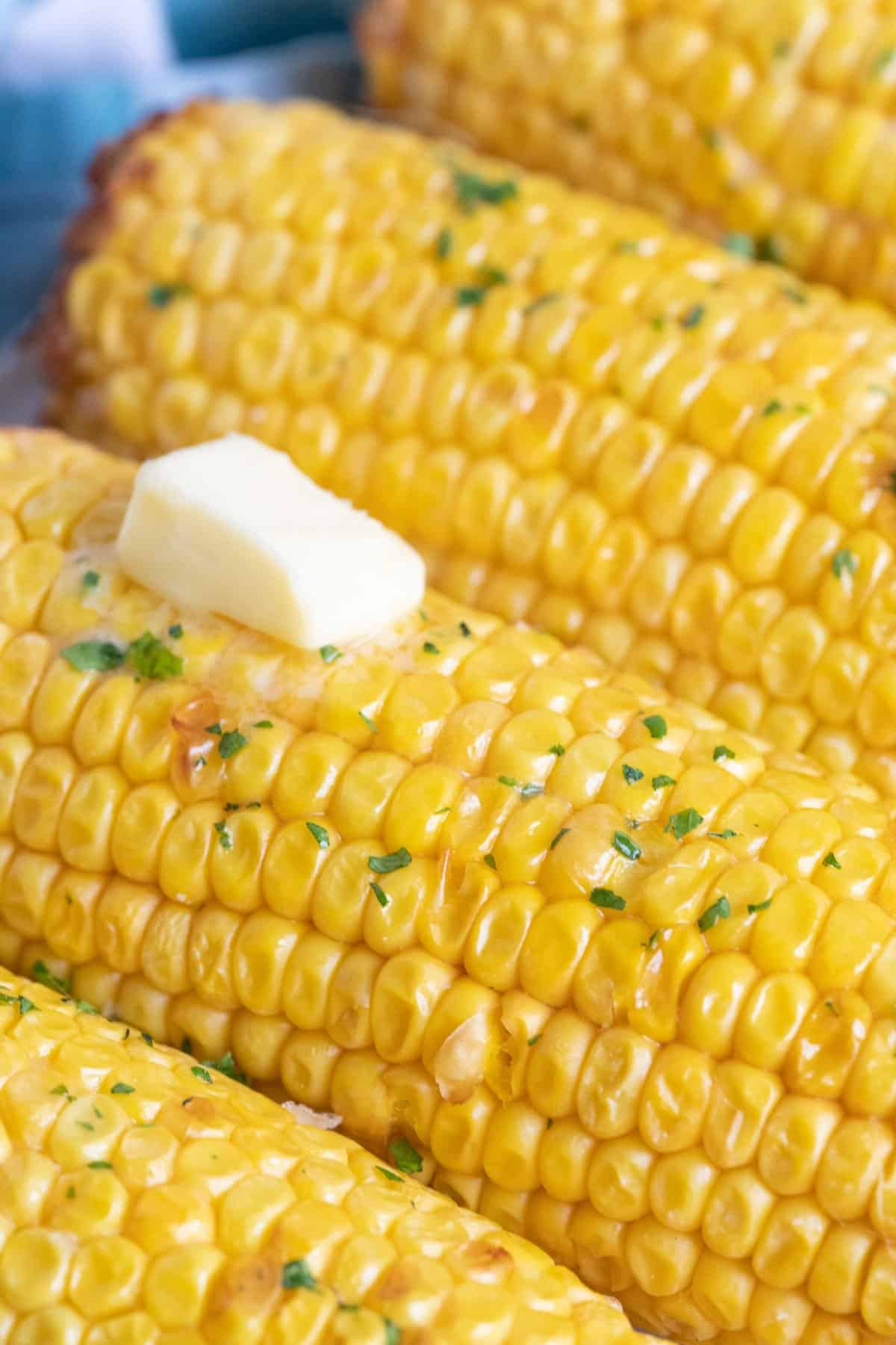 A close up photo of air fried corn on the cob.