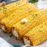 Air fryer corn on the cob with melted butter on top.