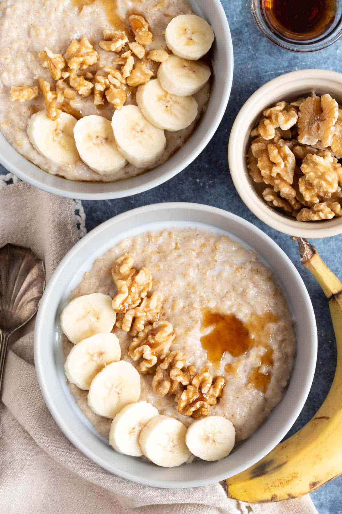 Banana porridge topped with sliced bananas and walnuts.