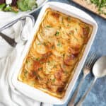 Boulangere potatoes in a white ovenproof dish.