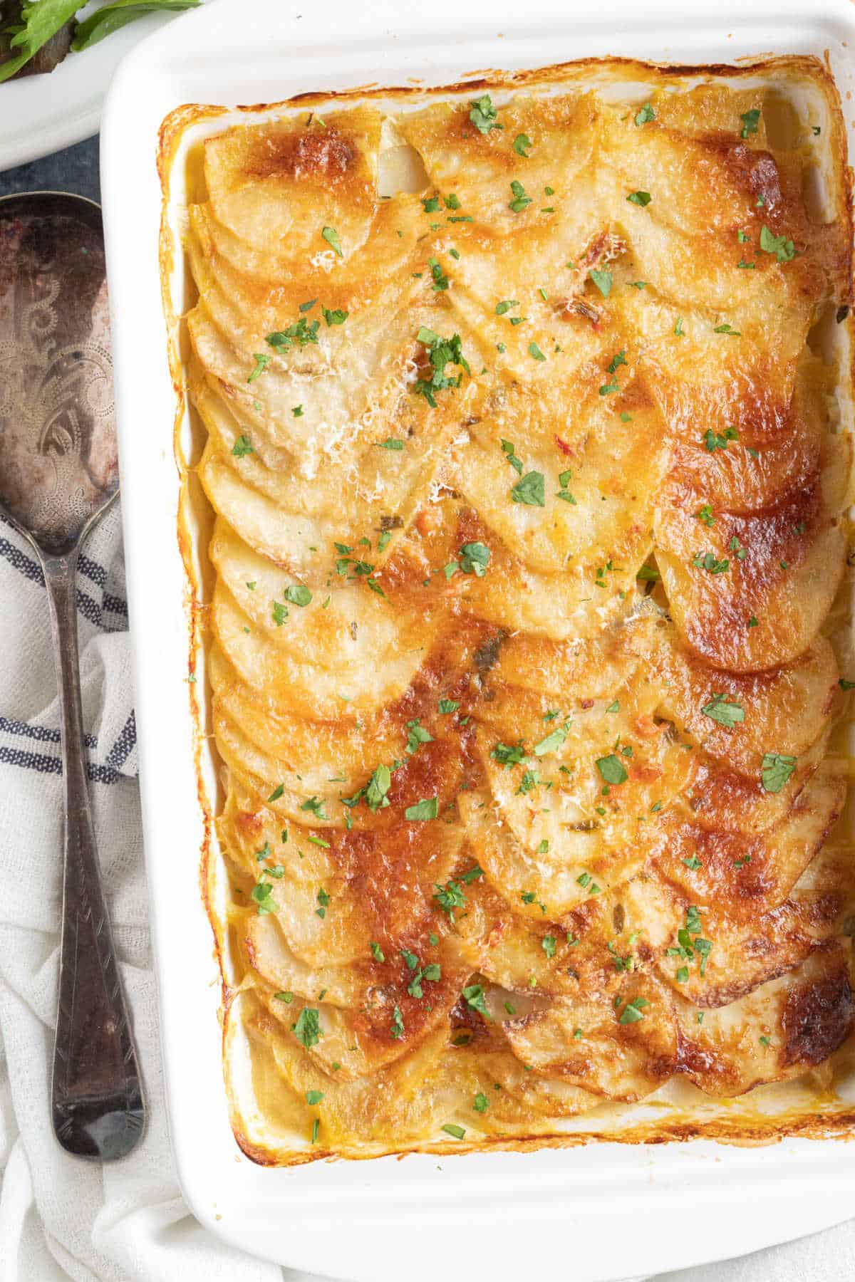 Boulangère potatoes in a white baking dish.