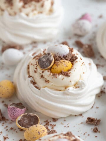 Easter meringue nests on a white platter.