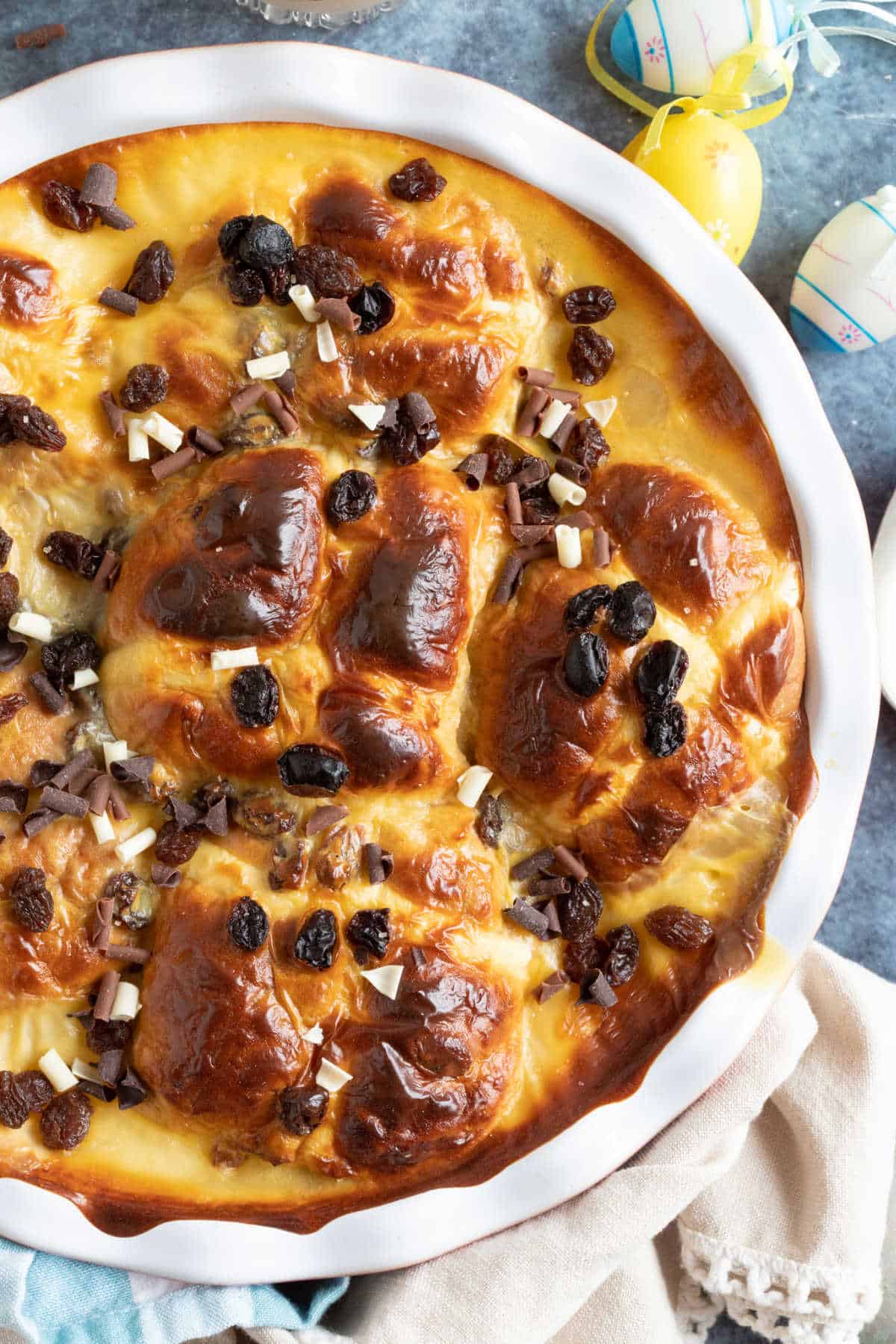 Hot cross bun bread and butter pudding in a baking dish.