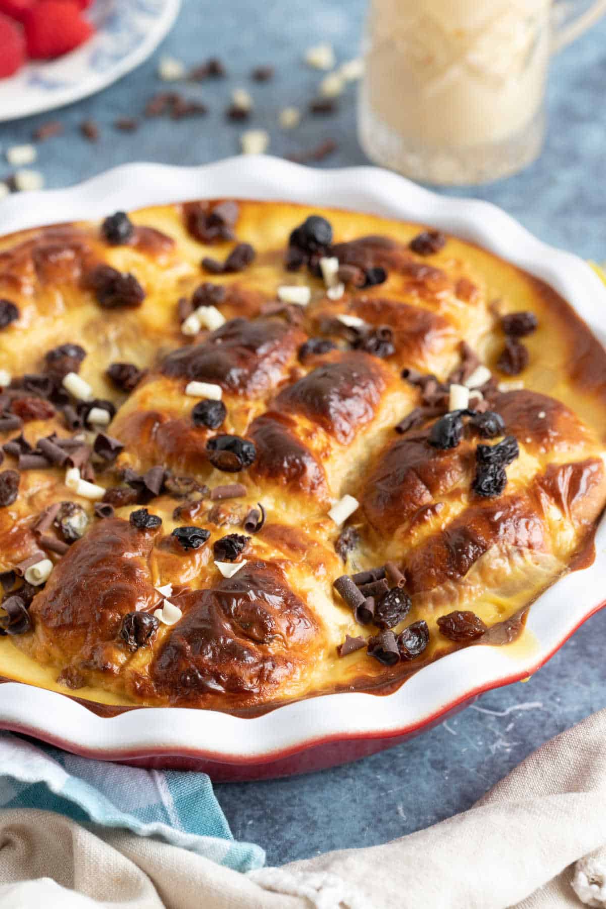 Hot cross bun bread and butter pudding sprinkled with chocolate chips.