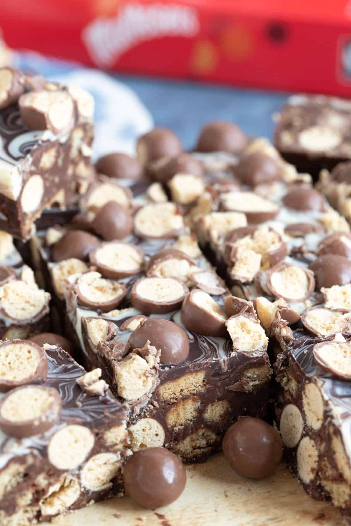 Malteser tiffin on a wooden board.