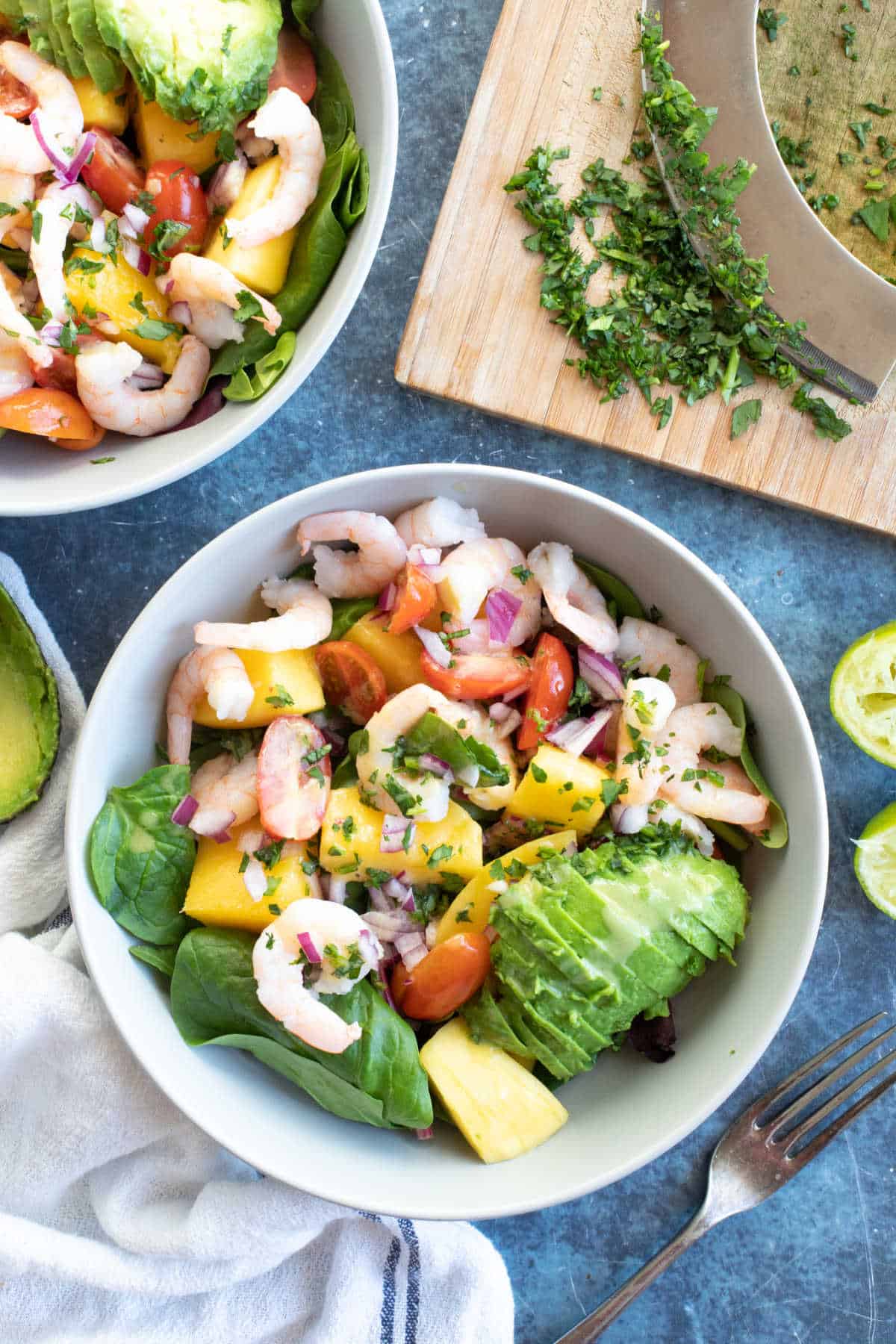 Prawn, avocado and mango salad in a grey bowl.