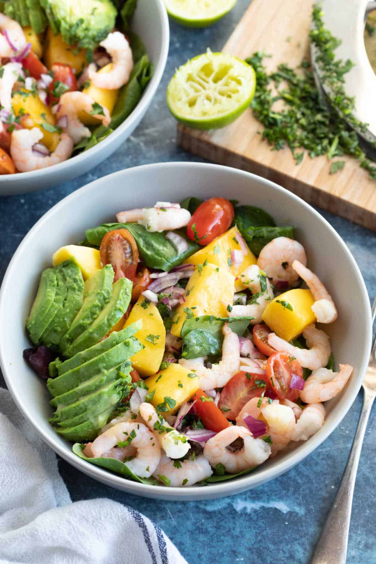 A bowl of prawn, avocado and mango salad with coriander.