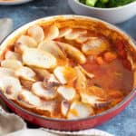 Sausage hotpot with thinly sliced potatoes.