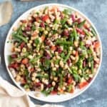 Five bean salad on a white serving plate.