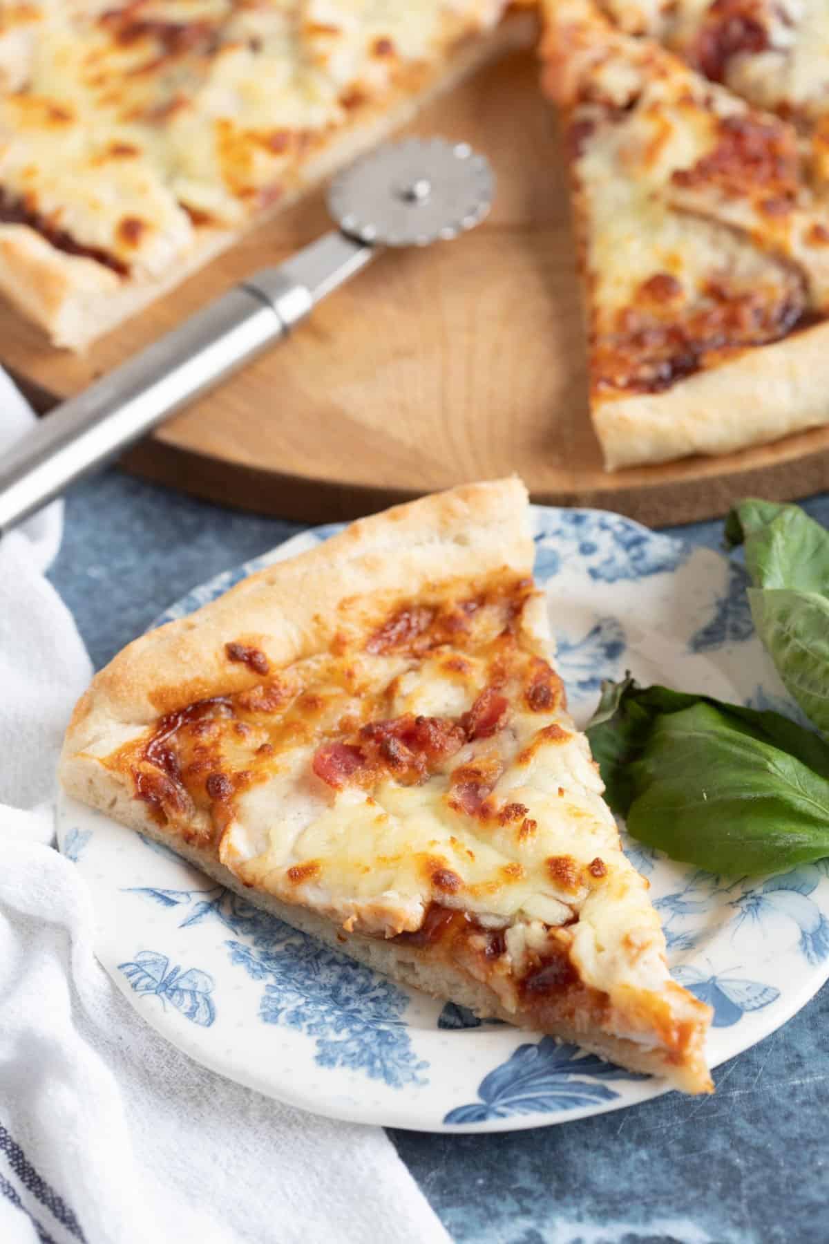 A slice of BBQ Chicken Pizza on a plate.