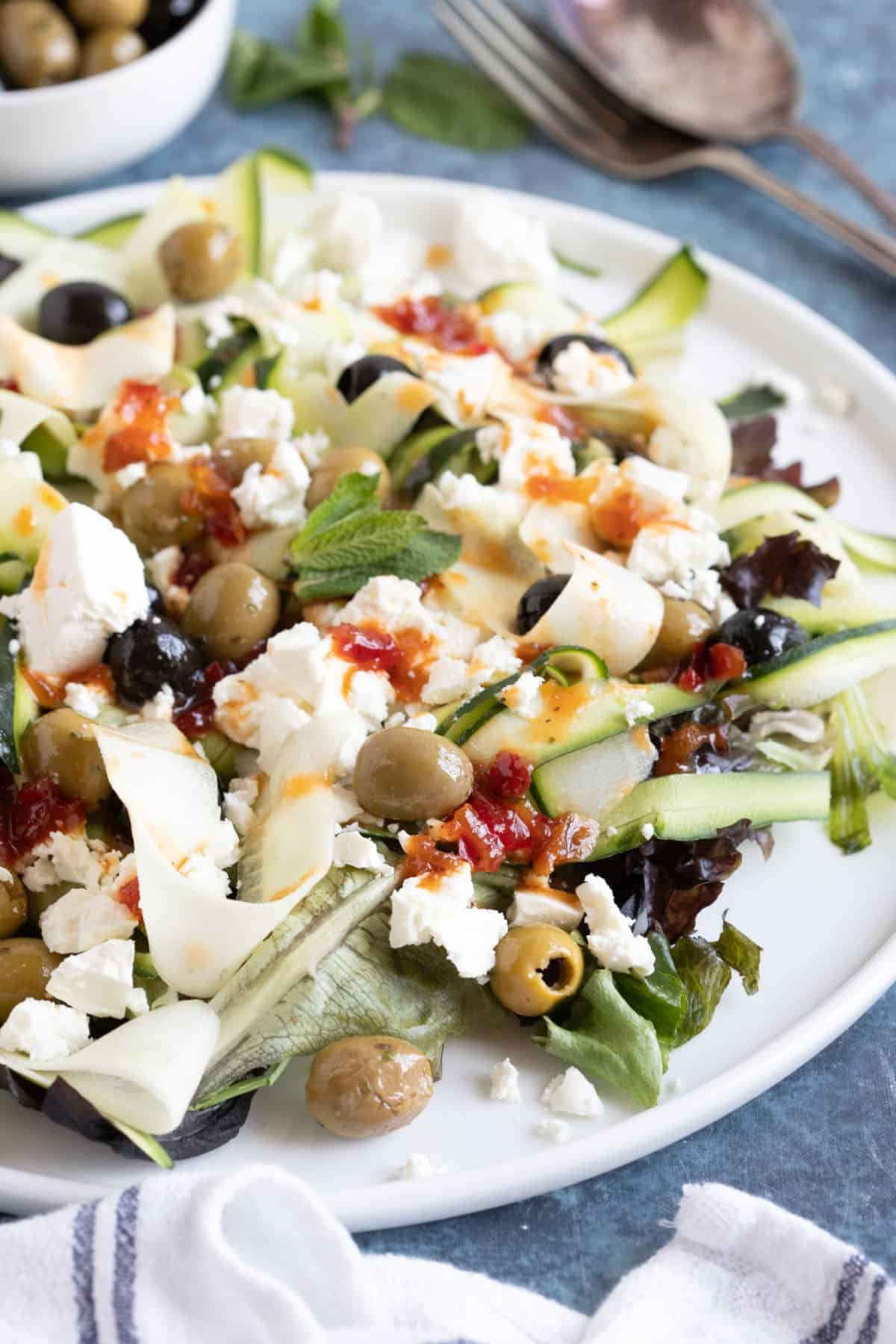 Courgette and feta salad on a serving plate.