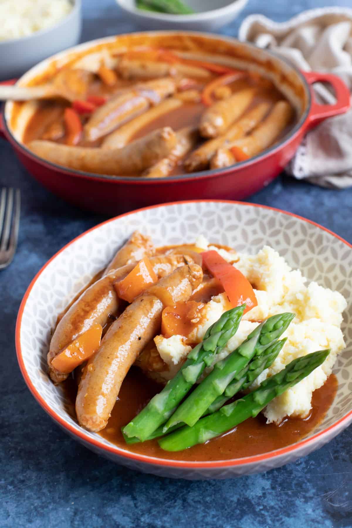 Sausage casserole with mashed potato and asparagus.