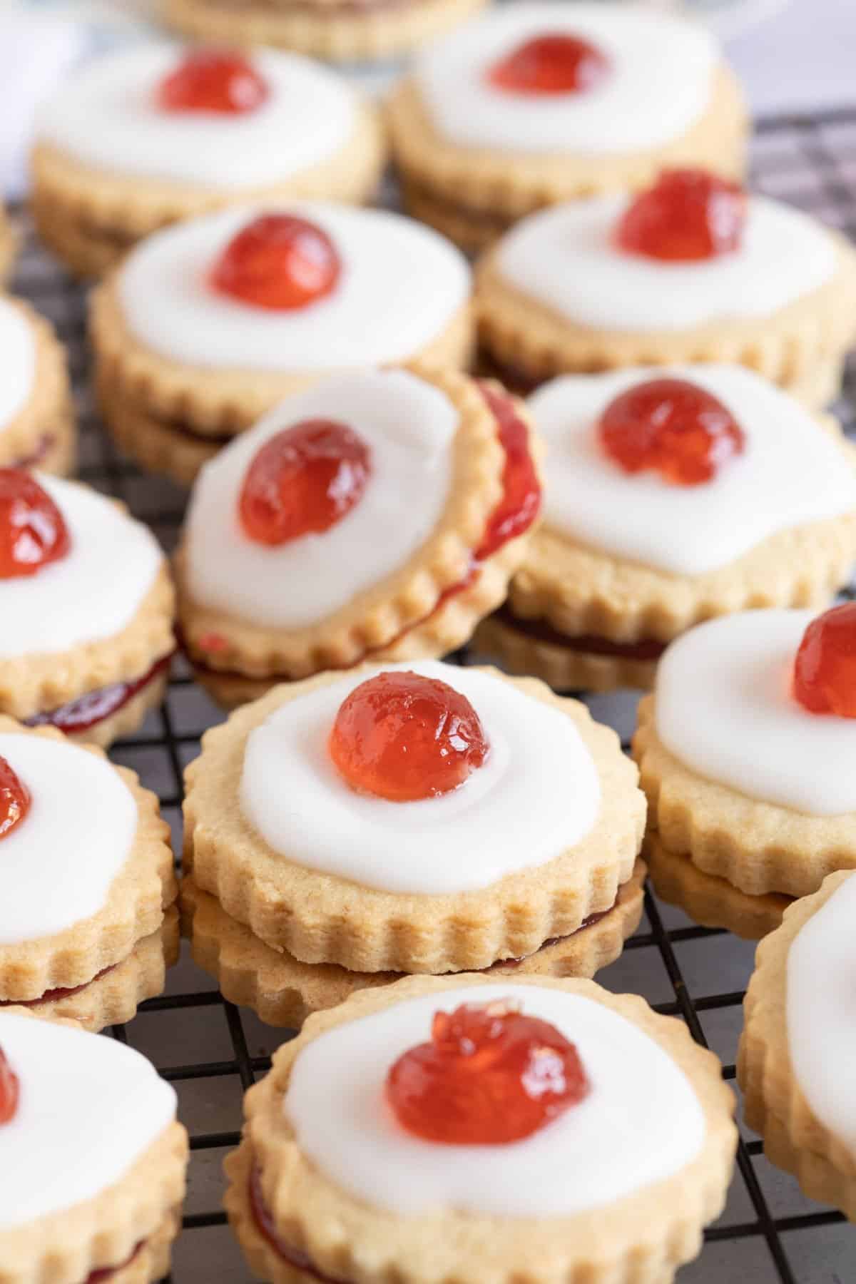 Empire biscuits on a wire cooling rack.