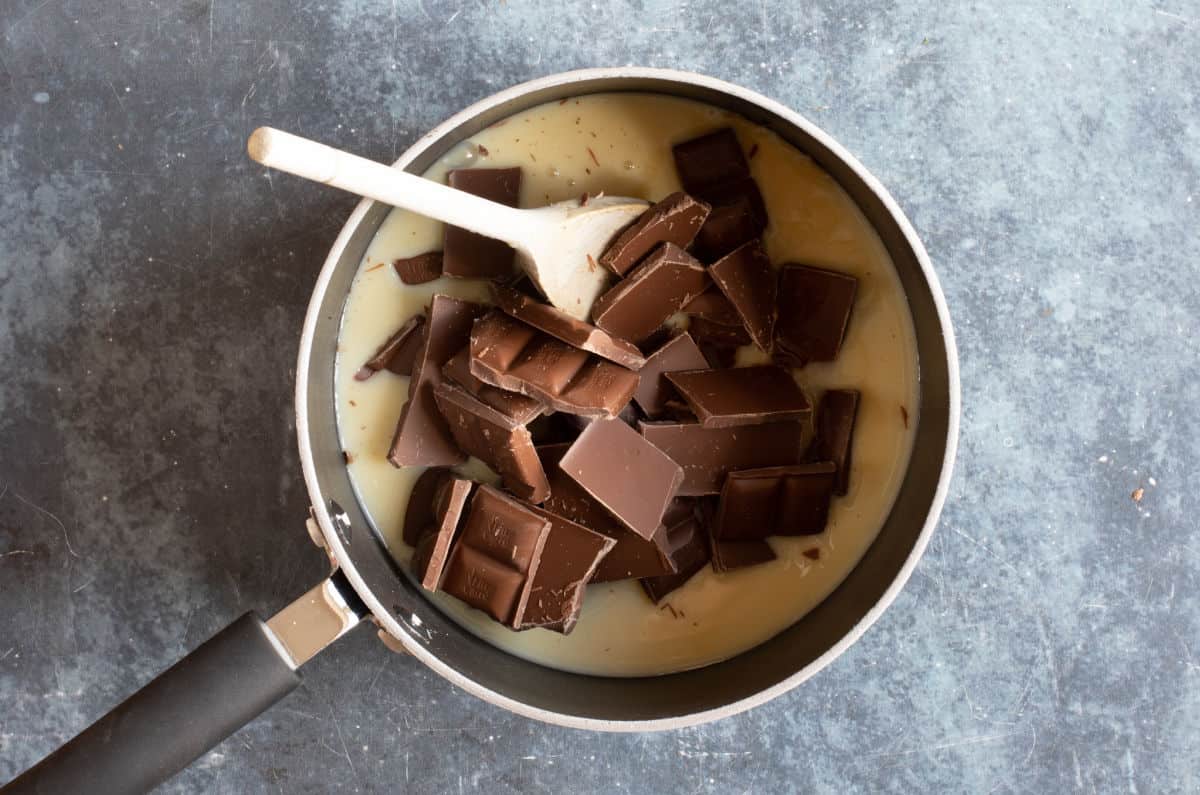 Condensed milk and chocolate in a pan.