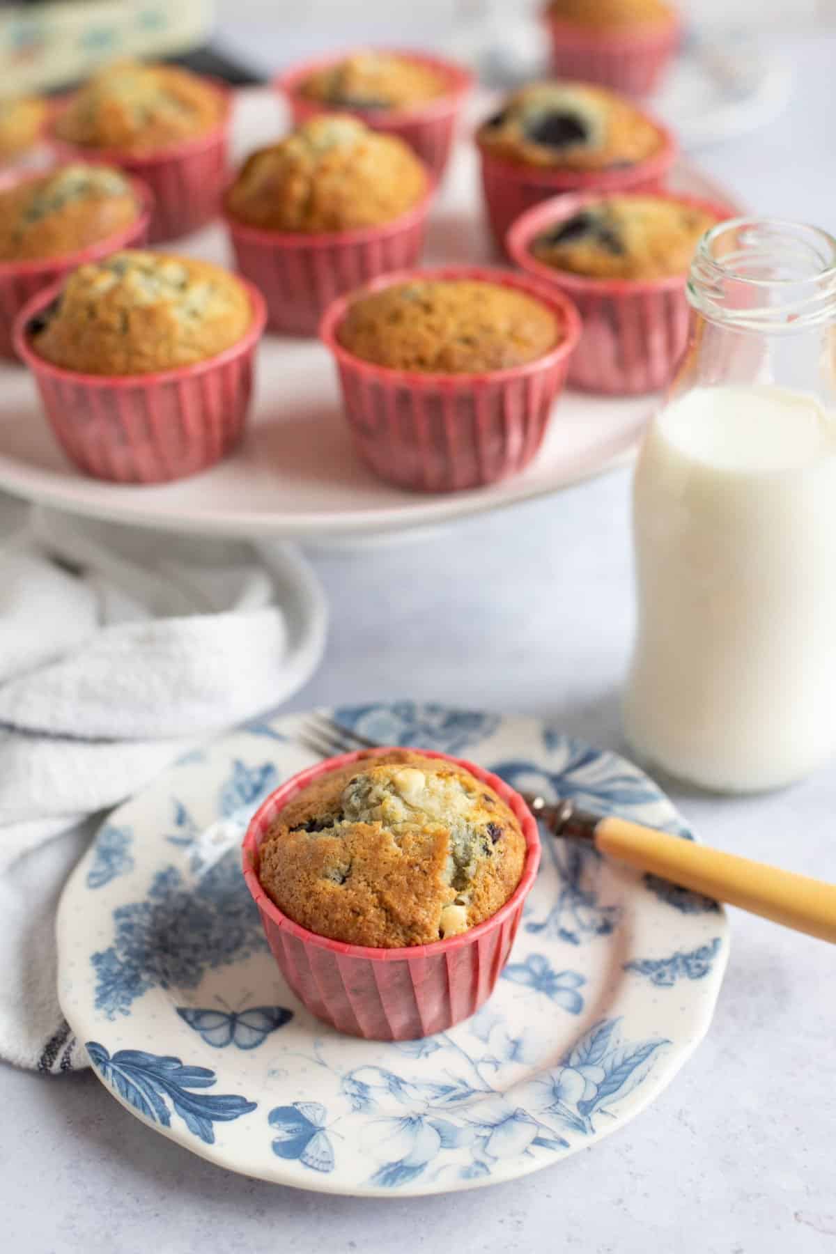 Fresh cherry muffin on a blue and white plate.