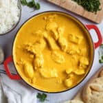 Chicken korma in a red pan.