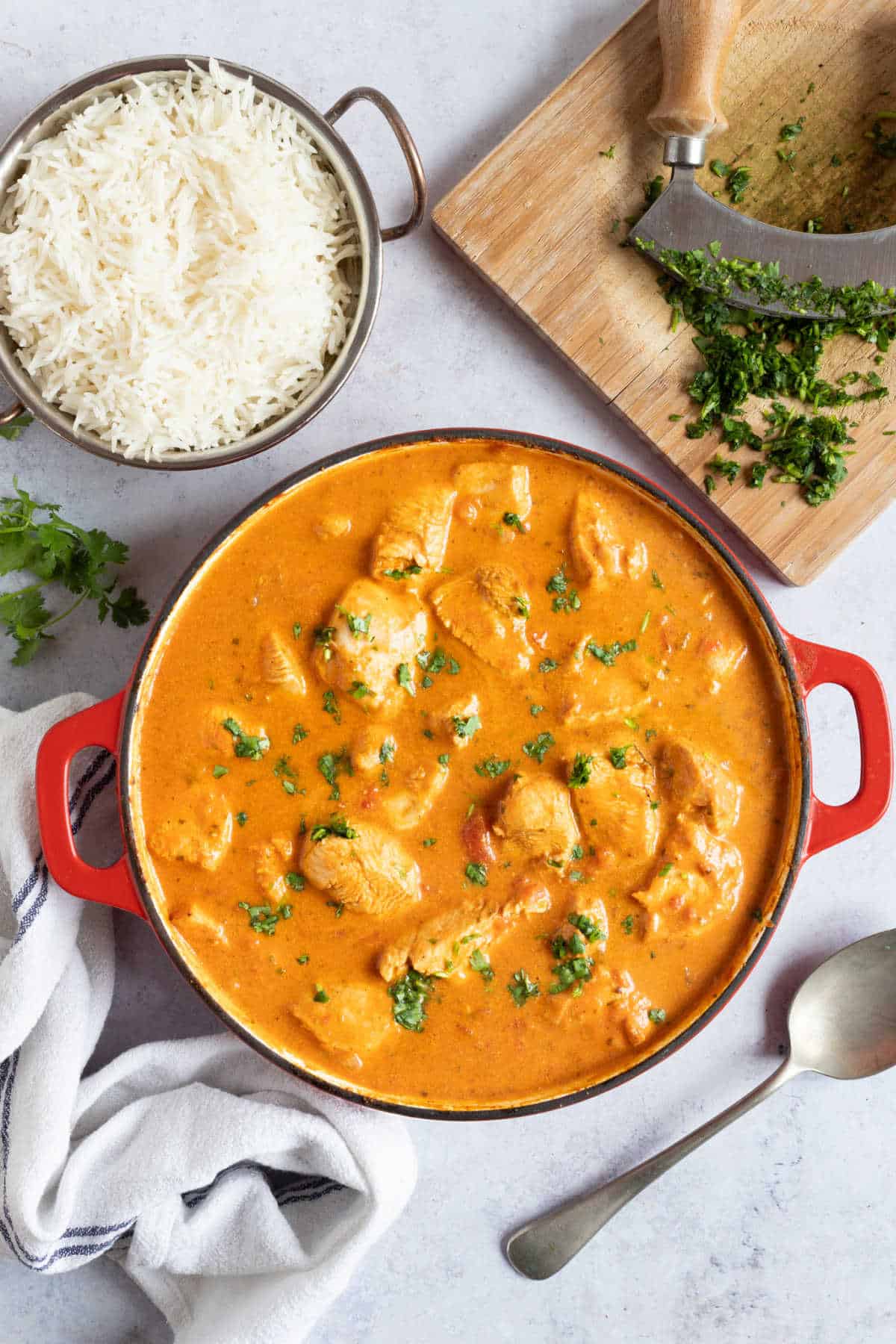 Homemade chicken tikka masala in a red pan.