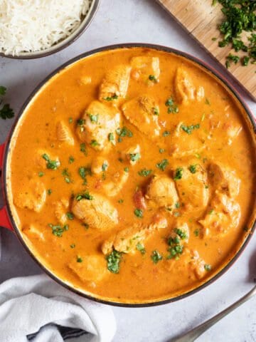 Chicken tikka masala in a red pan.