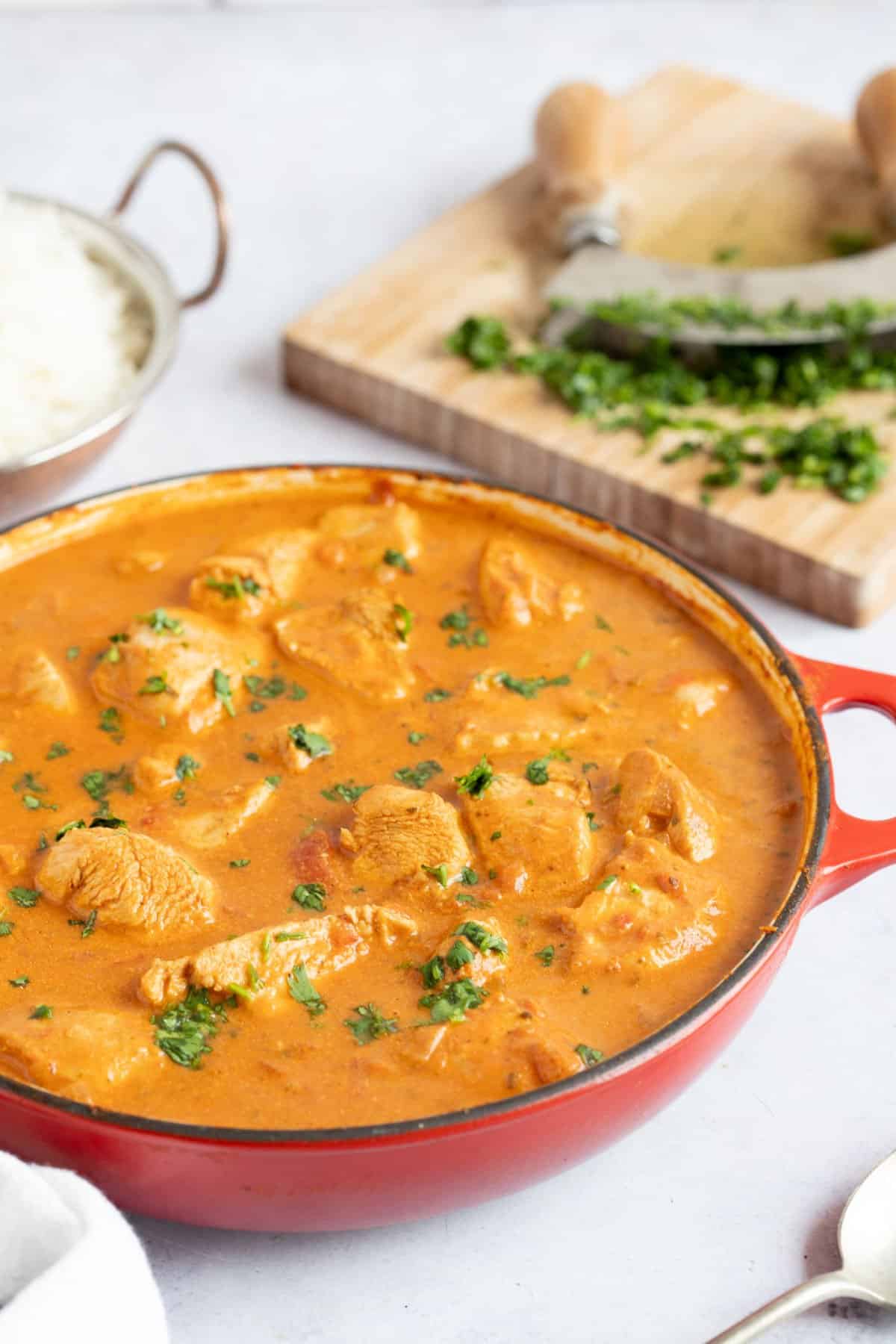 Chicken tikka masala in a red pan.