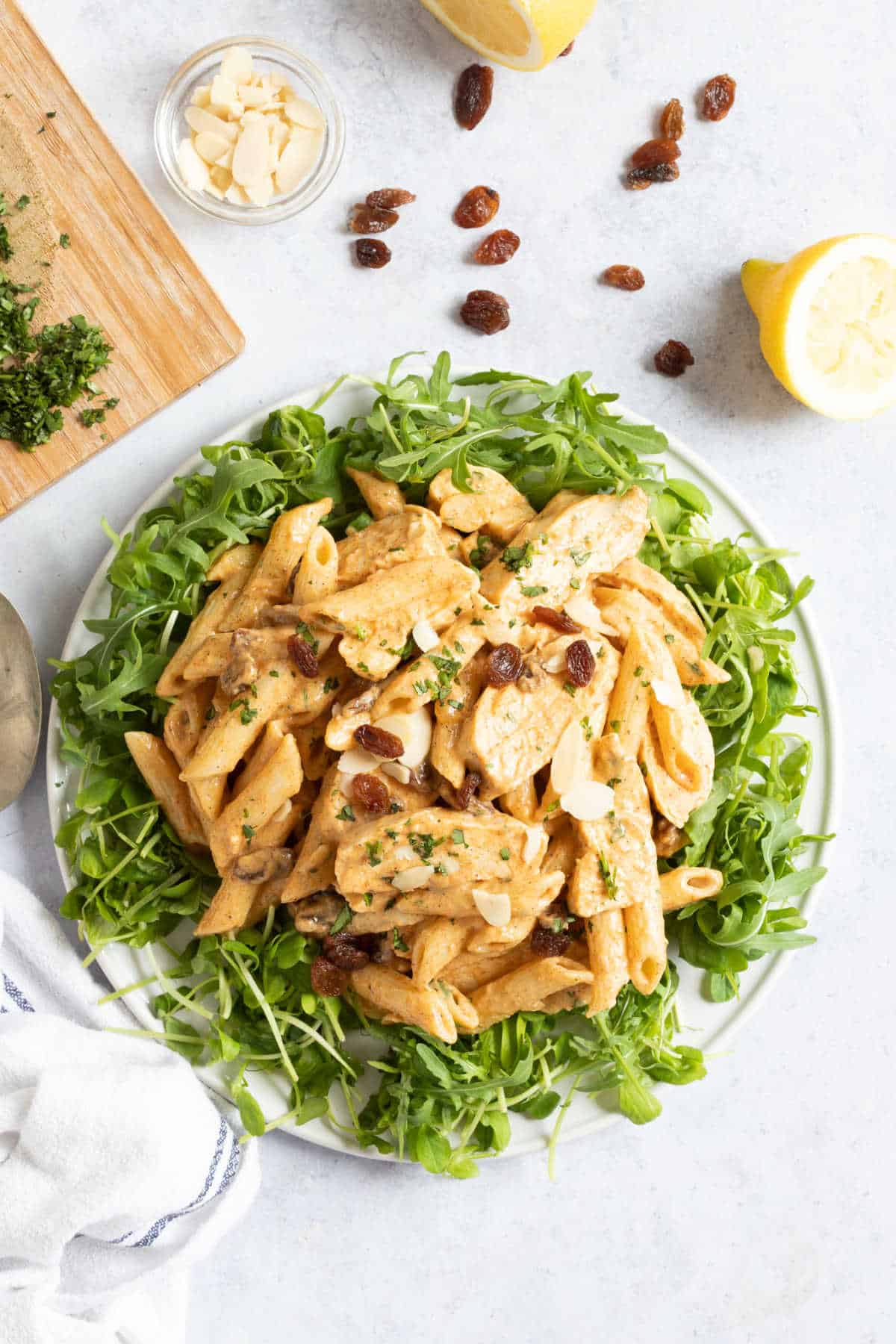 Coronation chicken pasta salad on a white serving platter.