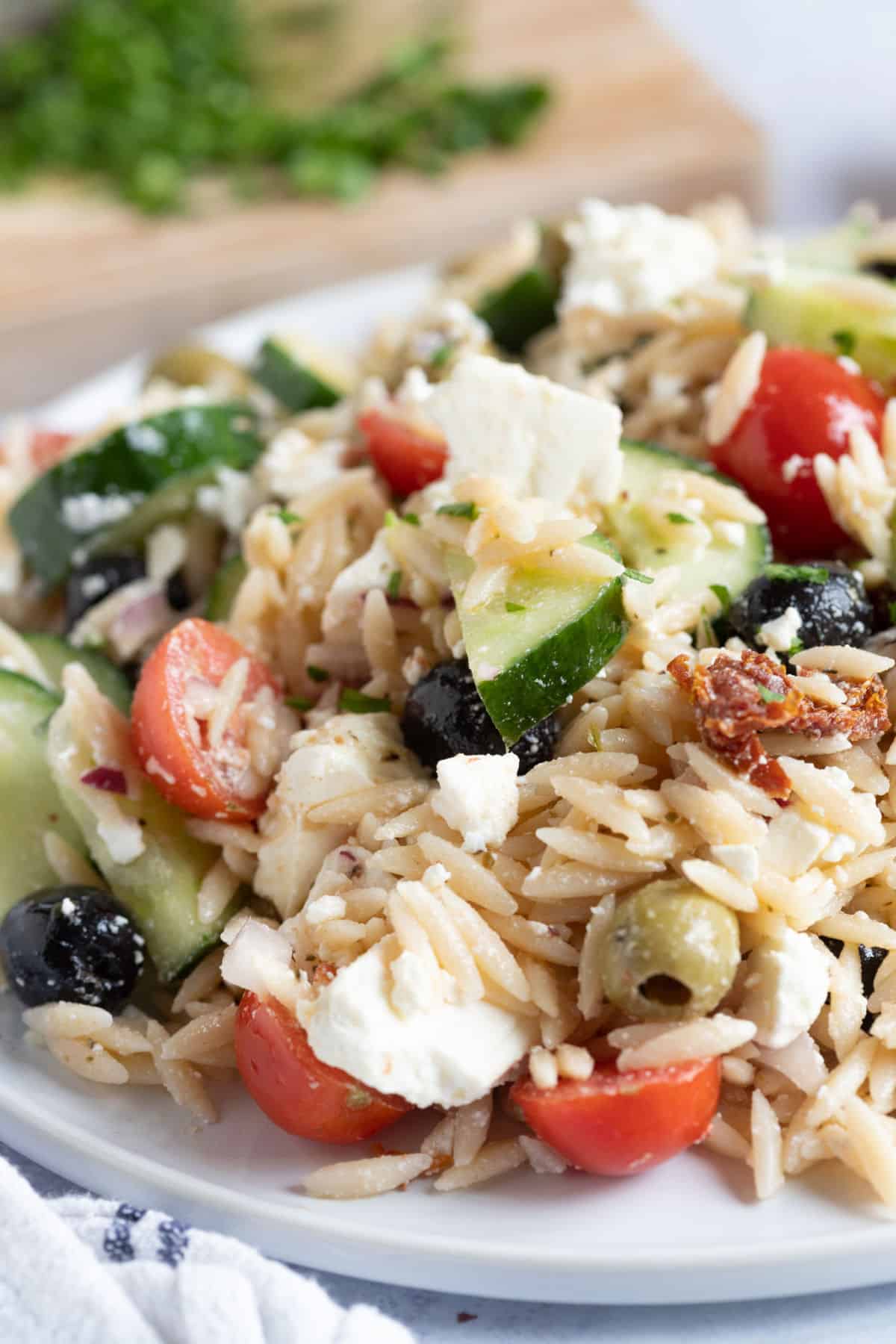 Greek Pasta Salad on a white serving plate.