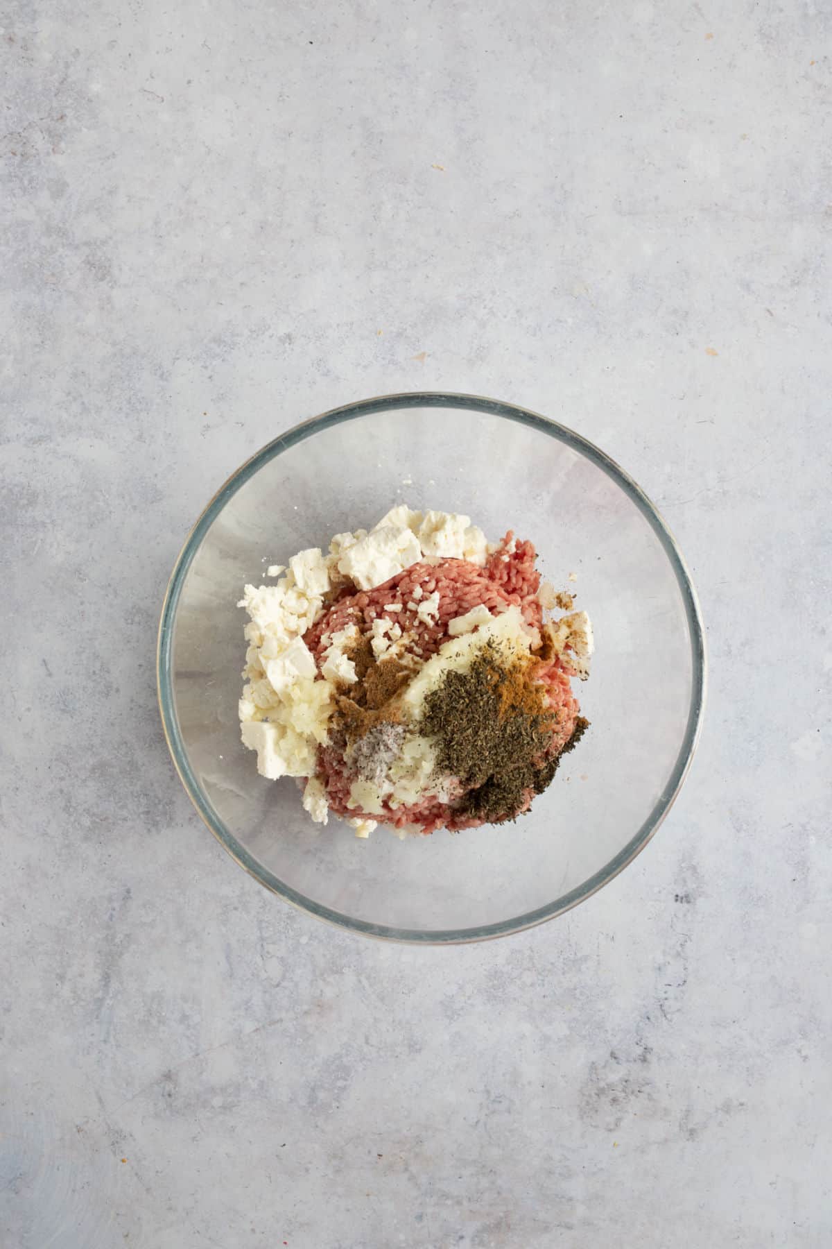 Lamb, feta and mint burger mixture in a mixing bowl.