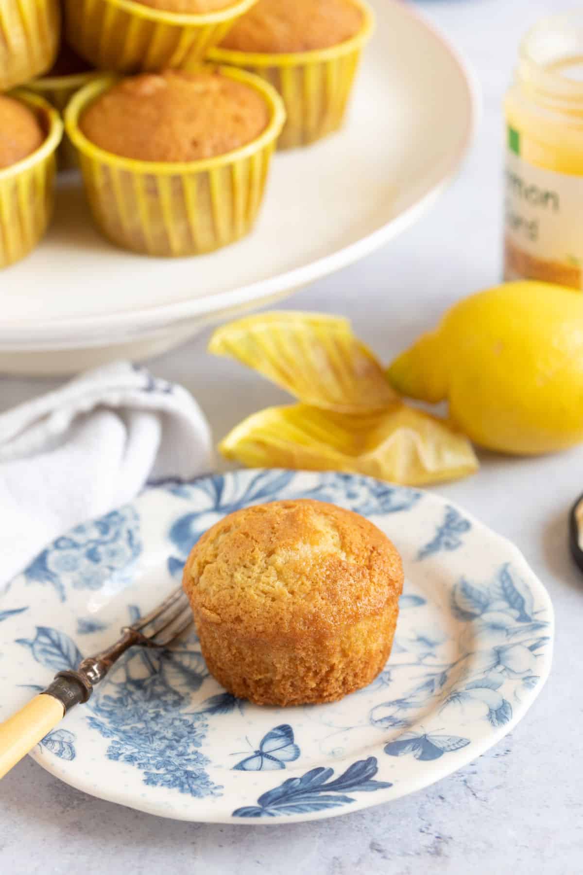 Lemon drizzle muffin on a blue and white plate.