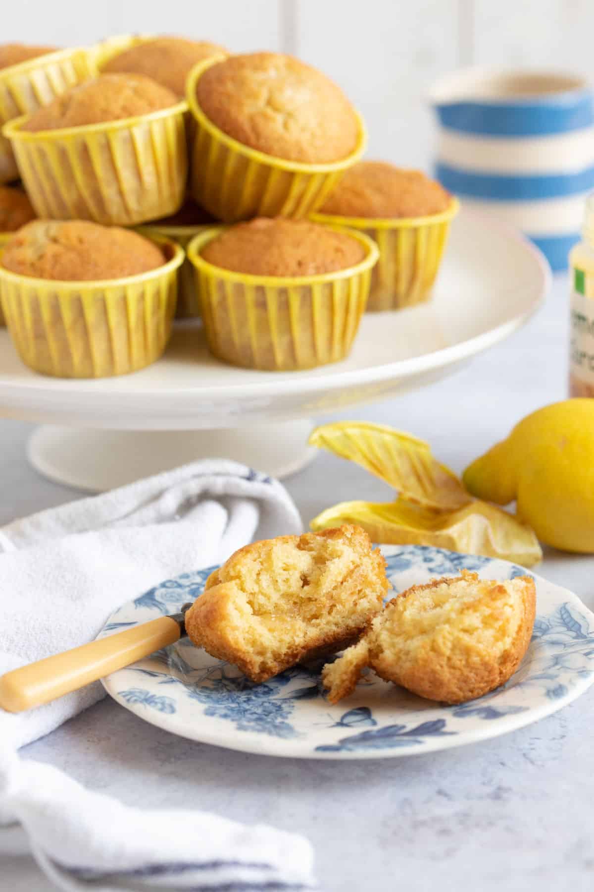 Lemon drizzle muffins on a cake stand.
