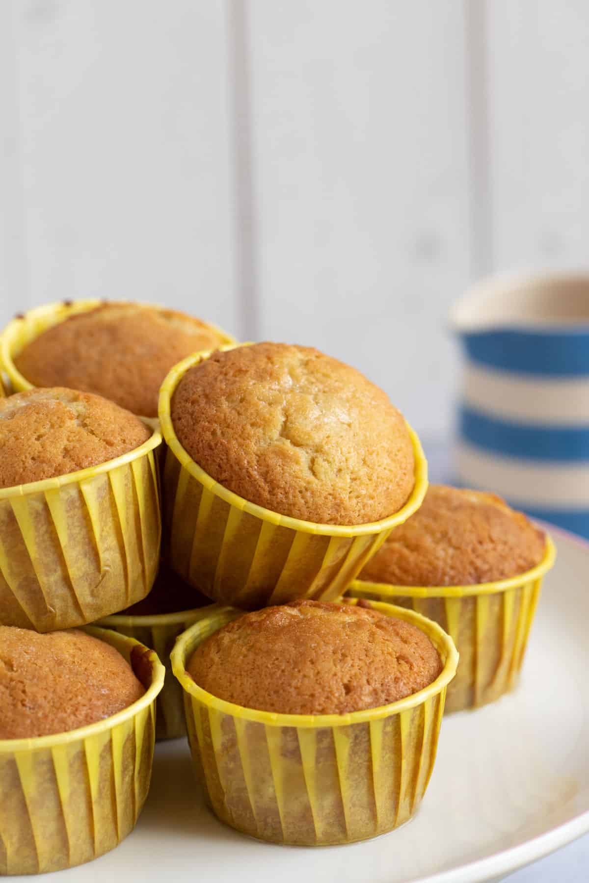 Lemon drizzle muffins on a cake stand.