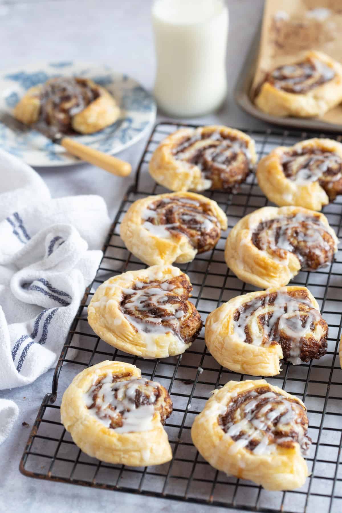 Baked cinnamon swirls on a wire rack.