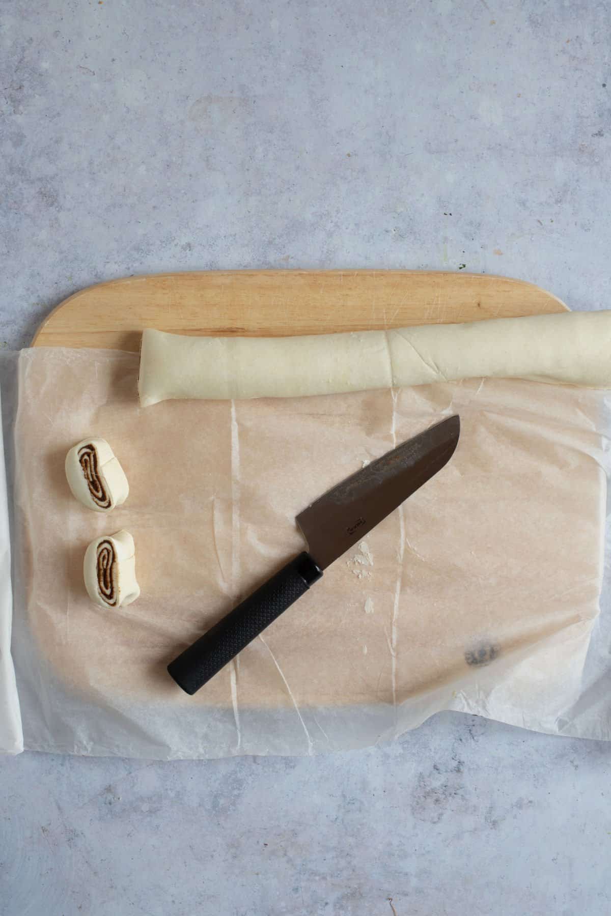 Cutting cinnamon swirls from the rolled up pastry.