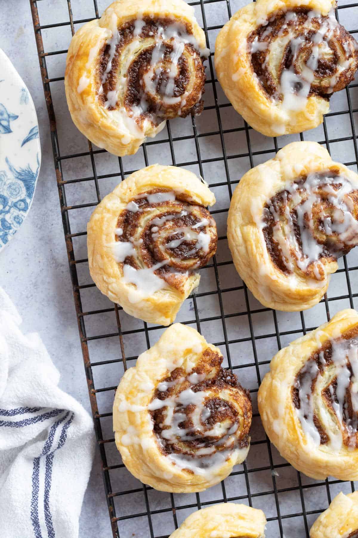 Cinnamon swirls made with puff pastry on a wire rack.