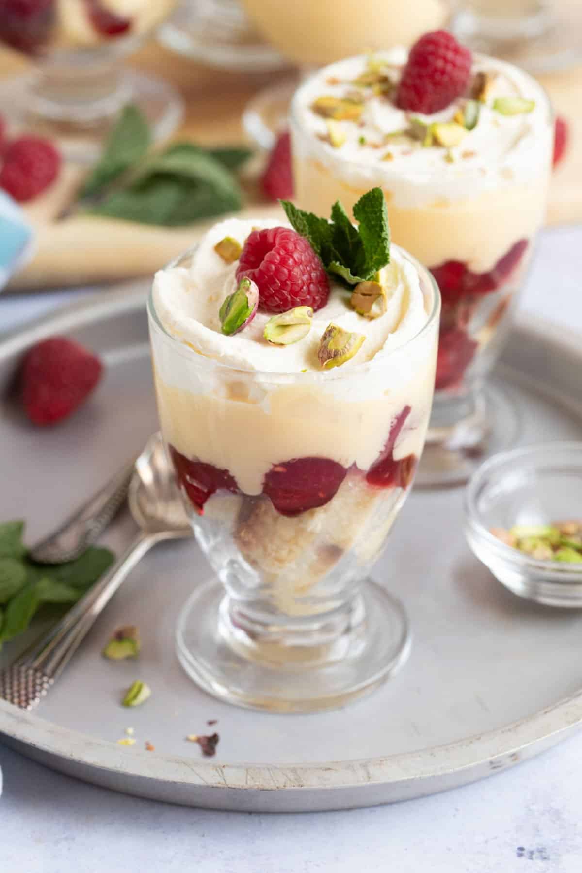 Sherry trifles topped with fresh raspberries.