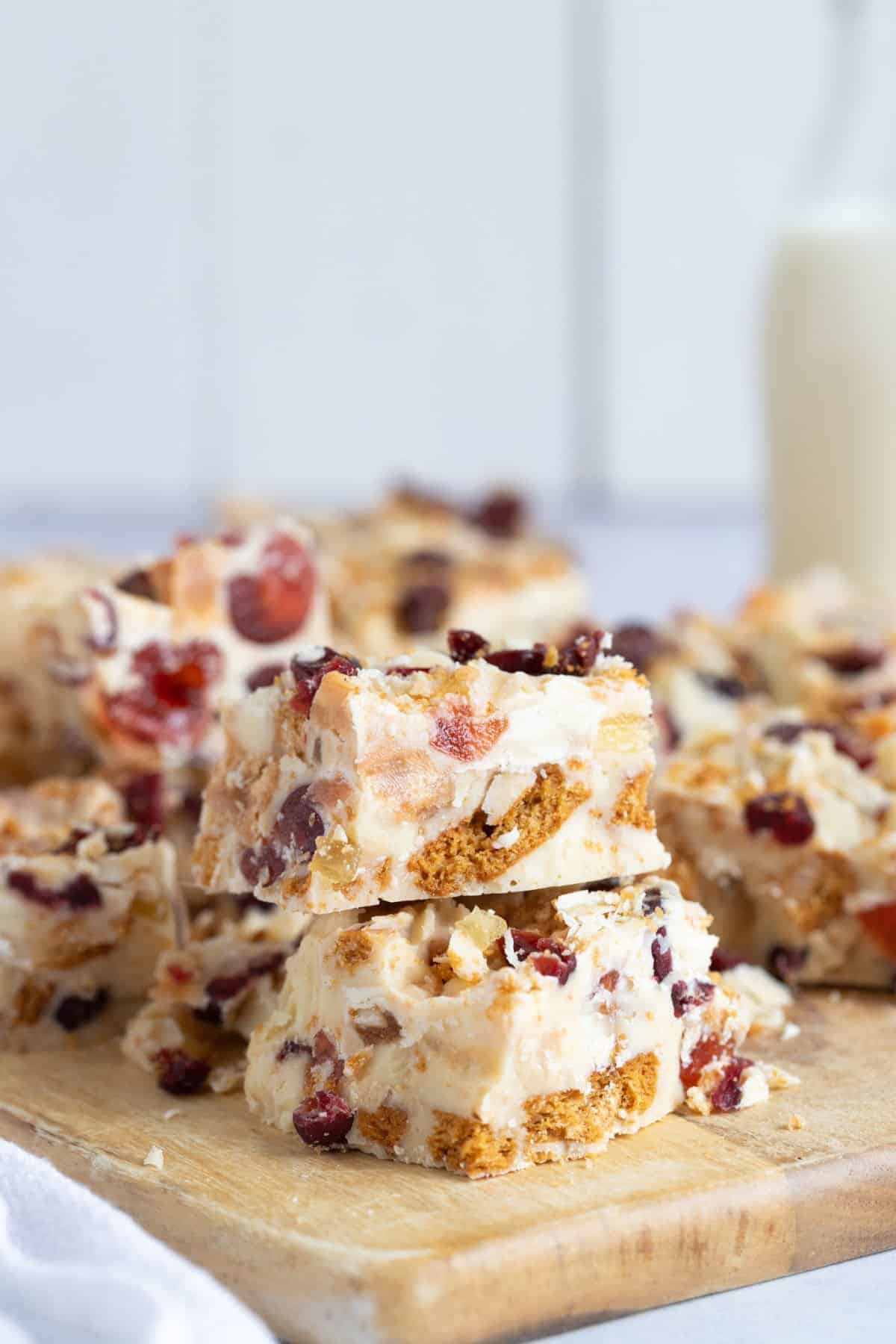 Slices of white chocolate tiffin on a chopping board.