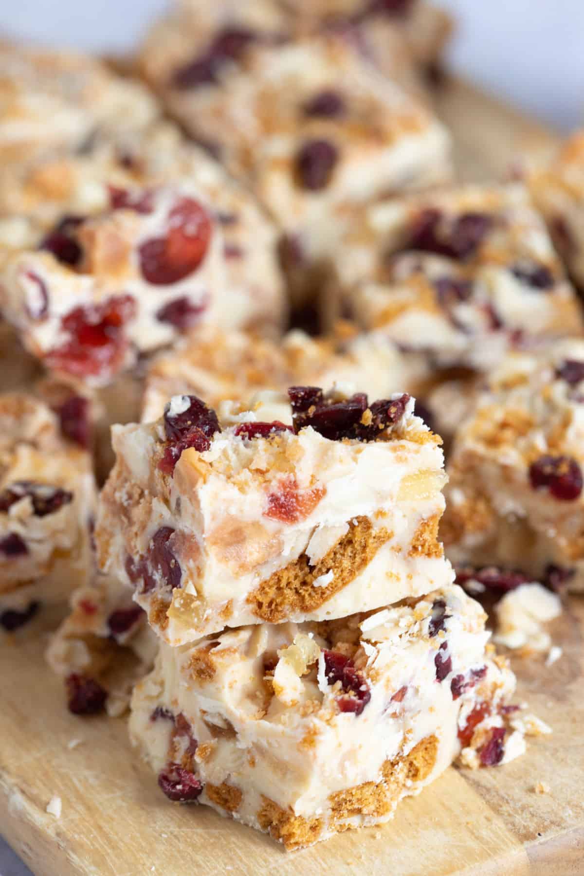 White chocolate tiffin squares on a wooden board.