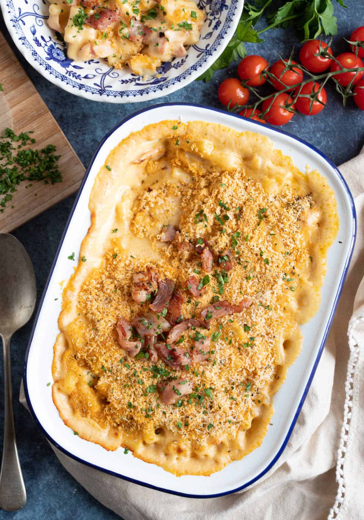 Bacon mac and cheese in a white enamel baking dish.