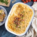 Bacon macaroni cheese with crispy bacon in a baking dish.