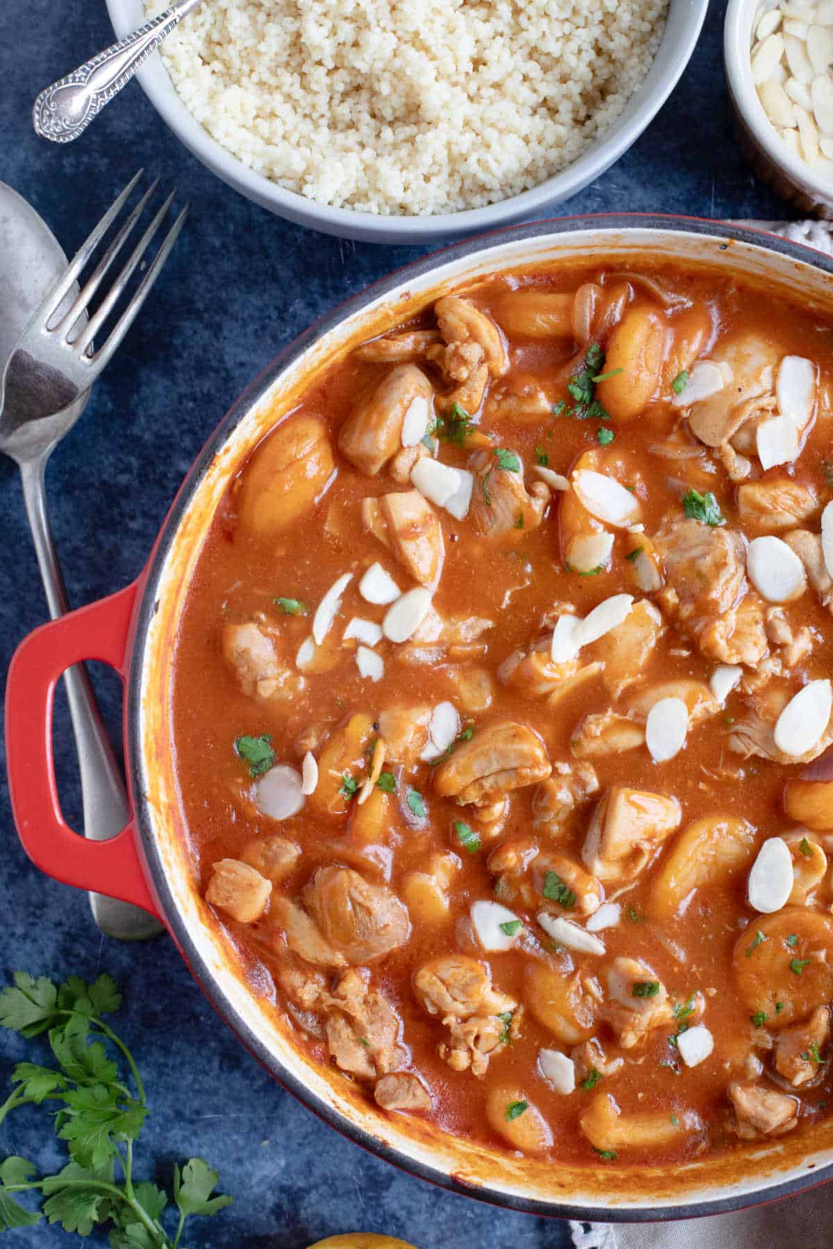 Chicken and apricot tagine garnished with flaked almonds.