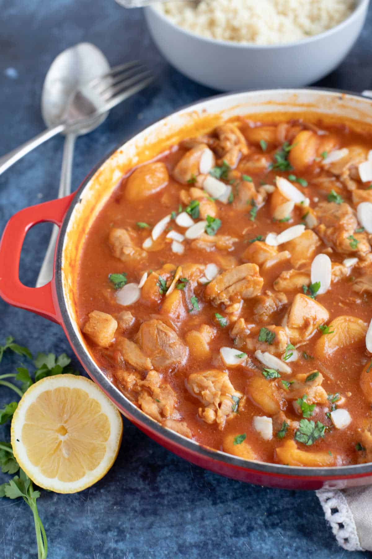Chicken and apricot tagine in a red shallow casserole.