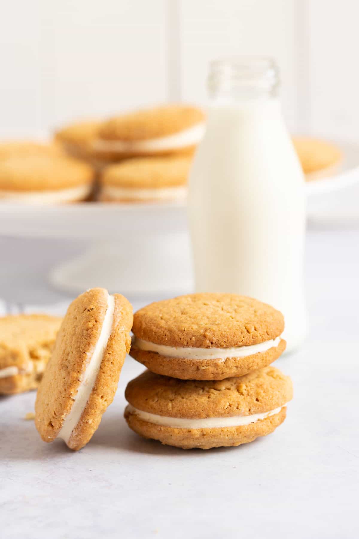 Gypsy cream sandwich cookies with a glass of milk.