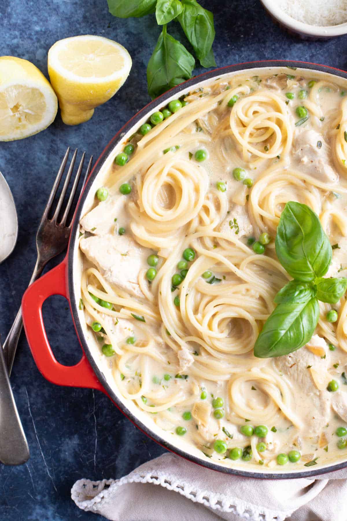 Creamy lemon chicken spaghetti ni a red pan.