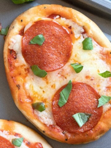 Naan bread pizza with basil.