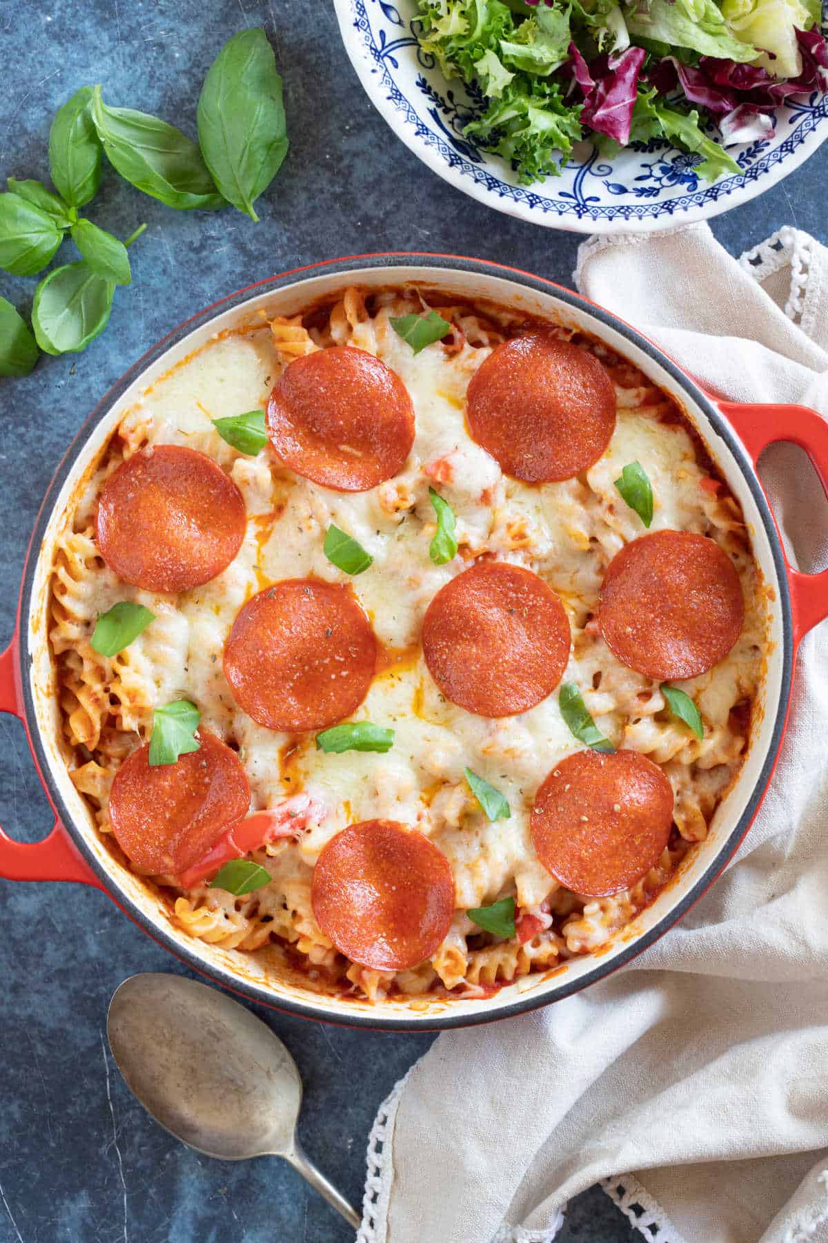 Pizza pasta bake in a red pan.