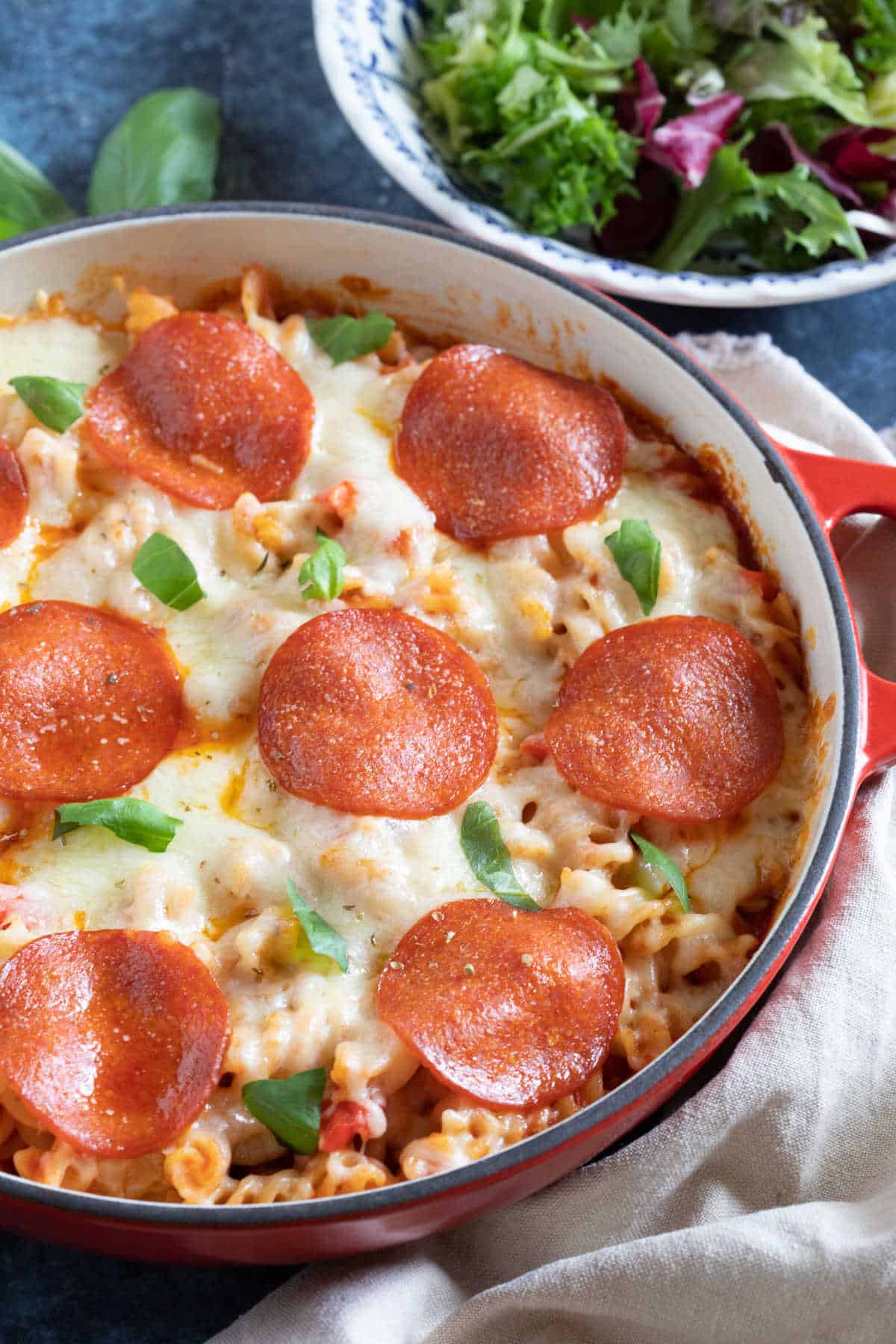 Pepperoni pizza pasta bake with a side salad.