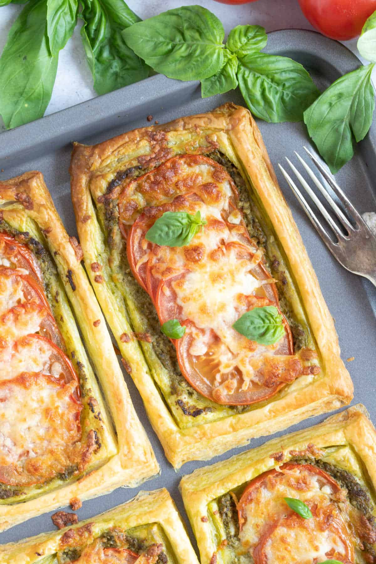 Puff pastry tart with tomatoes, mozzarella and pesto.