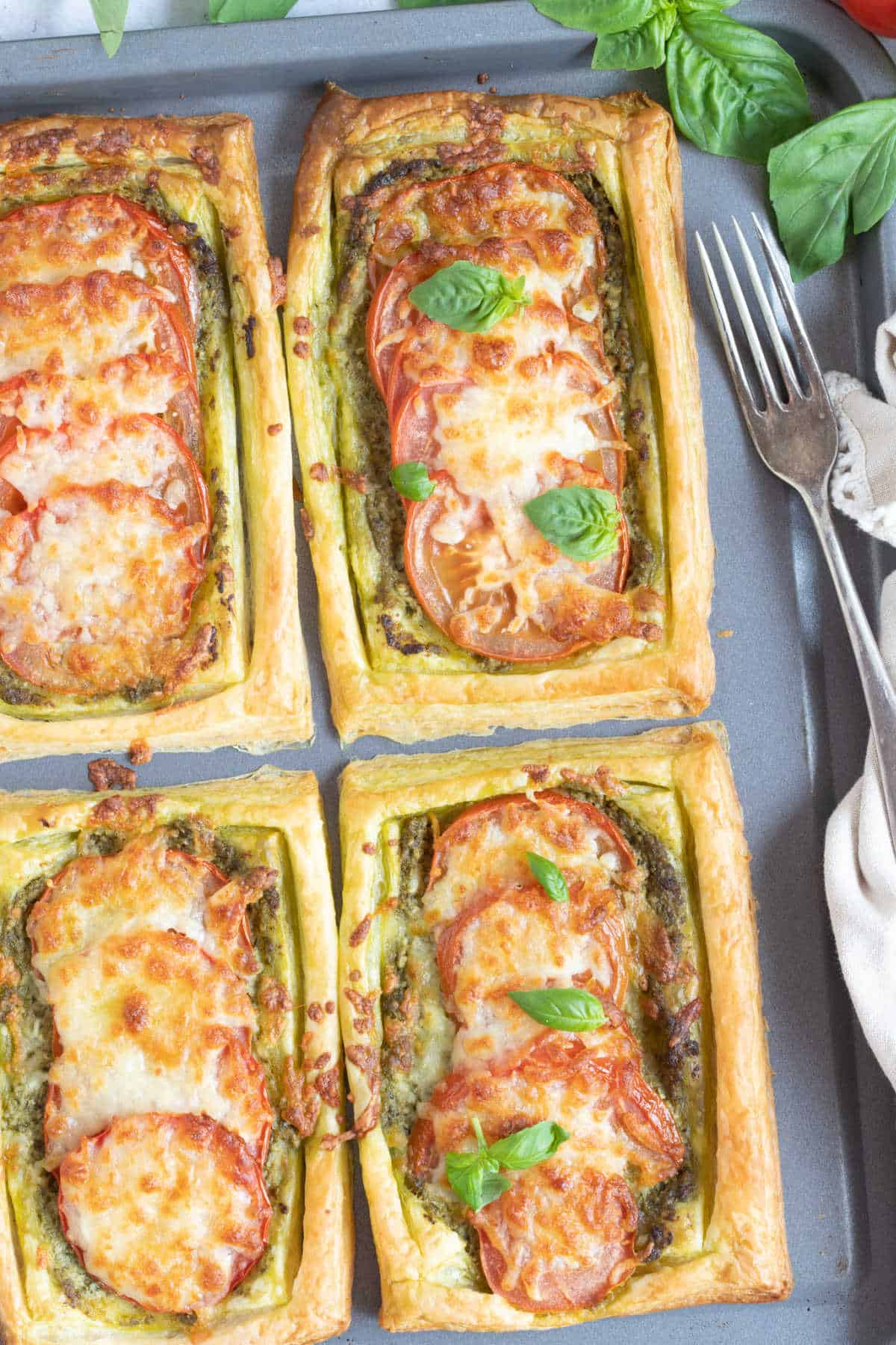 Savoury puff pastry tarts on a baking tray.