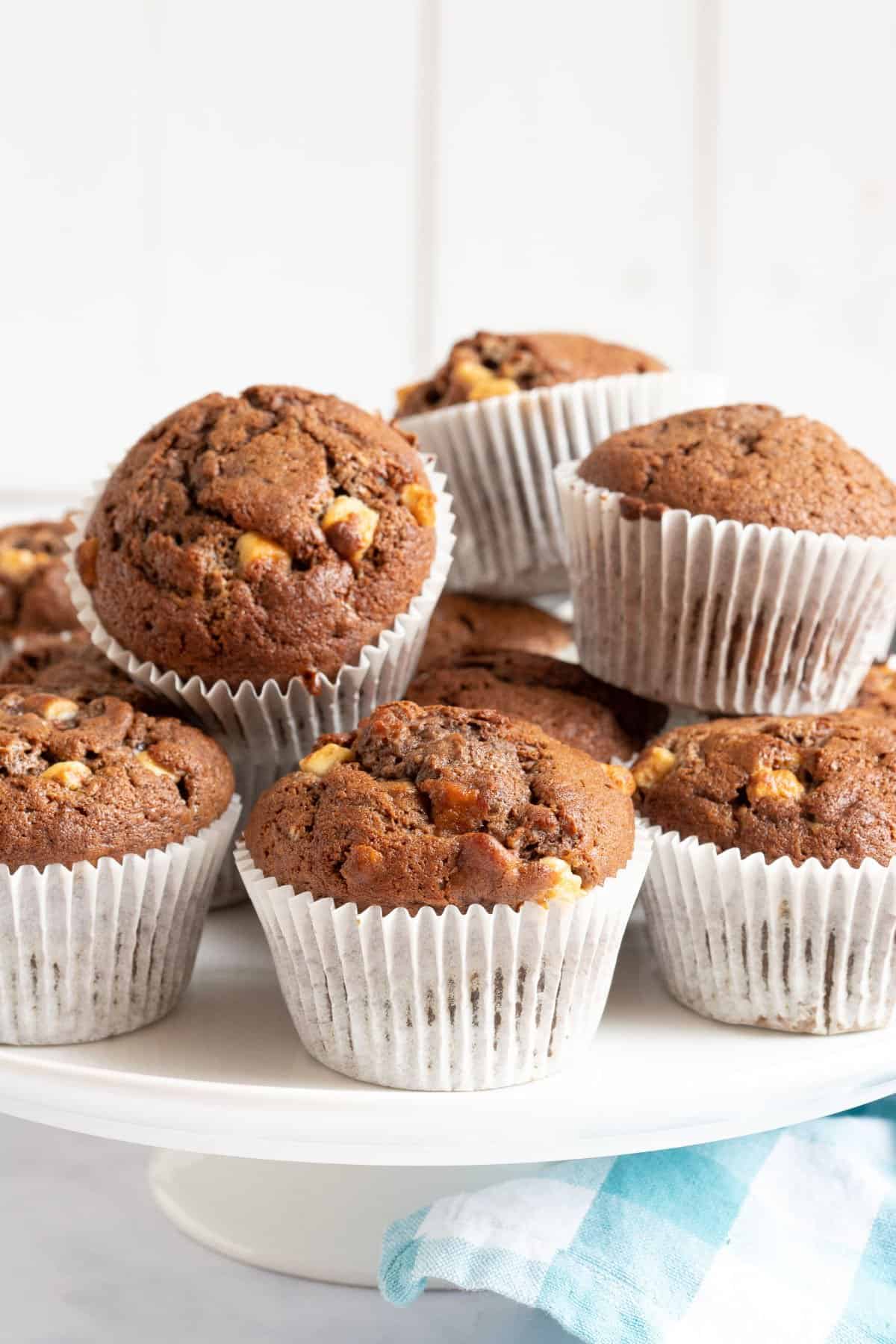 Chocolate banana muffins on a cake stand.