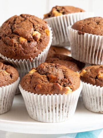 Chocolate banana muffins on a cake stand.