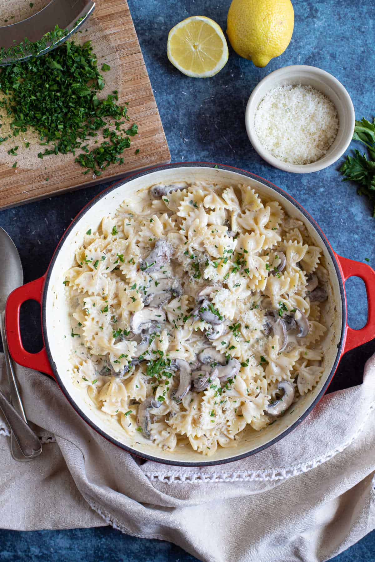 Creamy garlic and mushroom pasta in a red pan.
