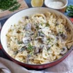 Garlic mushroom pasta in a red pan.